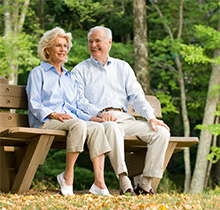 Couple relaxing on a bench.